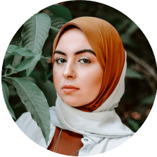 Portrait of a woman wearing a hijab looking thoughtful.