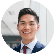 Portrait of a young Asian man in a business suit smiling.