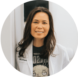 Portrait of a female dentist smiling in a white coat