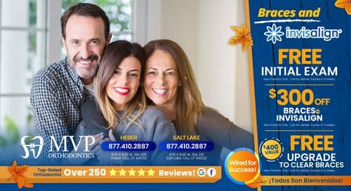 Promotional postcard for MVP Orthodontics featuring a family of three smiling warmly. The backdrop is a home interior with large windows. Offers include a free initial exam, $300 off braces or Invisalign, and a free upgrade to clear braces. Text highlights include 'Braces and Invisalign', 'FREE Initial Exam', '$300 OFF', and 'FREE UPGRADE to Clear Braces'. Contact information with phone numbers for Heber and Salt Lake City locations, along with the website 'MVP Orthodontics' logo, are prominently displayed.