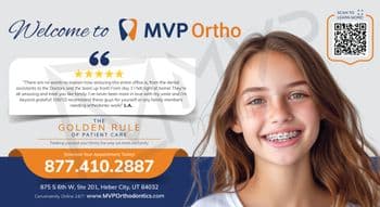 This promotional postcard for MVP Ortho features a cheerful, smiling young girl with braces. The left side of the postcard features the text 'Welcome to MVP Ortho' above a patient testimonial highlighted in a speech bubble praising the team's friendly and family-like treatment from day one. Below, the postcard emphasizes 'The Golden Rule of Patient Care,' ensuring every patient is treated like family. A QR code for more information is positioned on the top right, next to the smiling girl's image. Contact information, including the phone number and website, is prominently displayed at the bottom, inviting appointments and online visits.