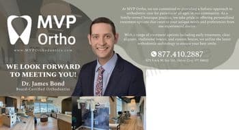 This promotional postcard from MVP Ortho showcases a modern, elegant orthodontic office interior. The left side of the postcard features a professional portrait of Dr. James Bond, a board-certified orthodontist, dressed in a blue suit with a floral tie, smiling confidently at the viewer. The right side overlays images of the stylish and spacious clinic interiors, including the reception area, treatment rooms, and advanced dental equipment, emphasizing a welcoming and technologically advanced environment. Prominent text above reads 'We look forward to meeting you!' emphasizing personal patient care. Contact information and the practice’s website are clearly displayed at the bottom, inviting potential patients to schedule a consultation.