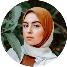 Portrait of a woman wearing a hijab looking thoughtful.