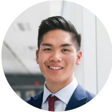 Portrait of a young Asian man in a business suit smiling.