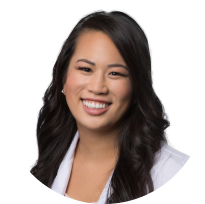 Portrait of a smiling Asian female dentist in professional attire