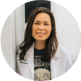 Portrait of a female dentist smiling in a white coat